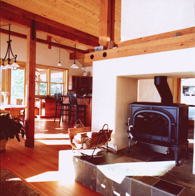 
The centralized wood-burning stove and hearth provides character, energy-efficient warmth, and a unique way to separate the rooms of the wide-open floor plan.
